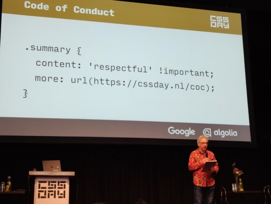 Jeremy Keith in front of slide:

Code of Conduct

.summary {
  content: 'respectful' !important;
  more: URL(http://cssday.nl/coc);
}