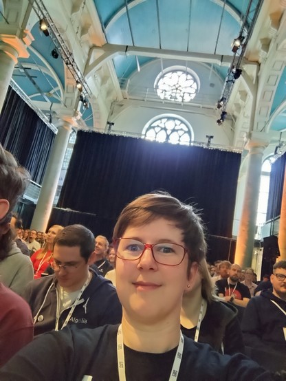 Selfie inside the venue - me in the foreground, pretty vaulted church roof above and behind me.