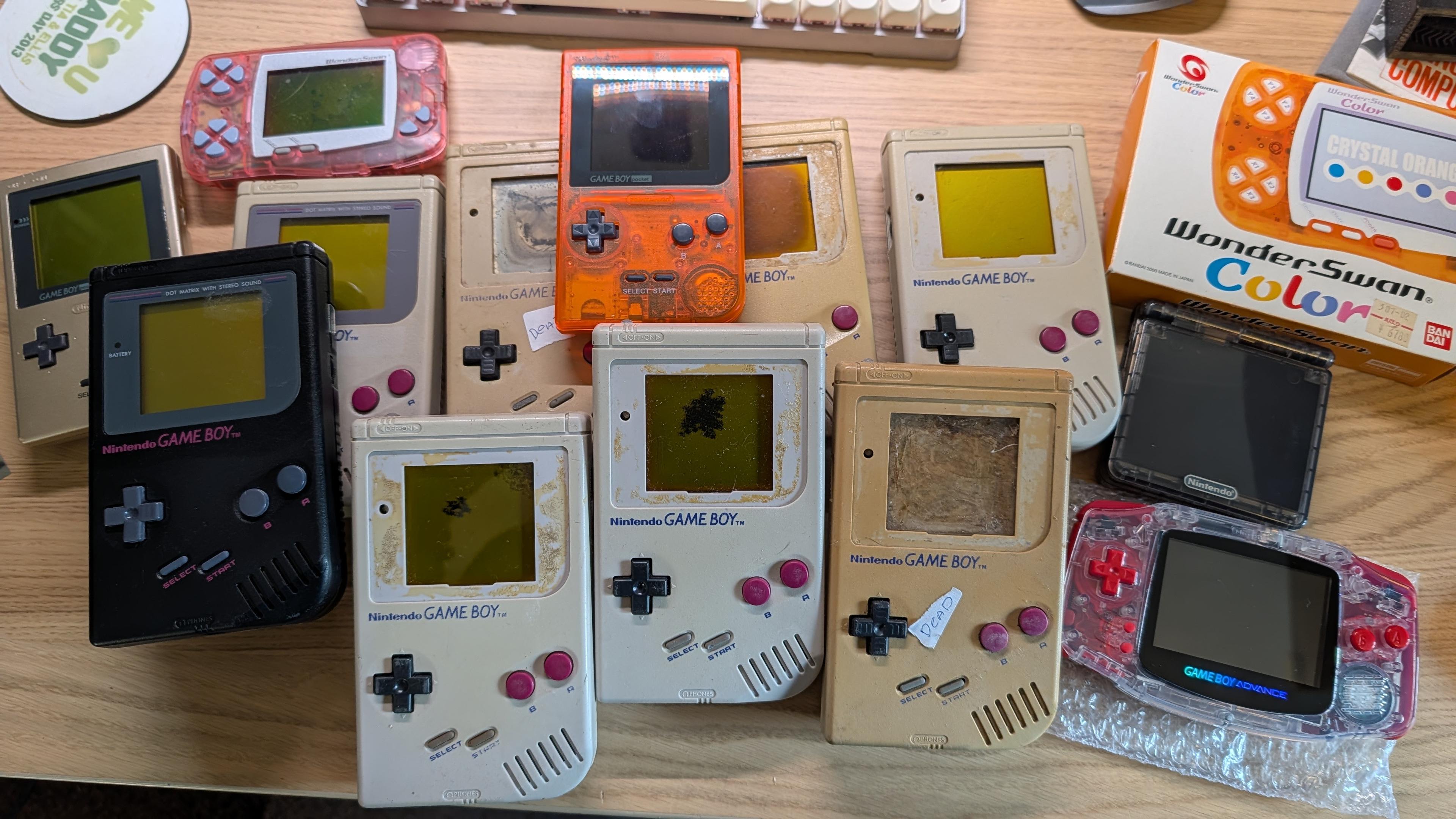 A collection of sad looking gameboys amongst some very fancy looking ones.