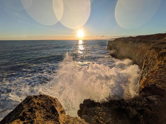 Waves breaking over the cliffs in Tarragona during sunset