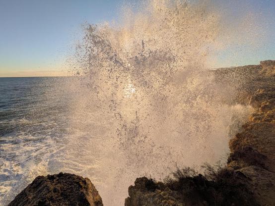Waves breaking over the cliffs in Tarragona during sunset