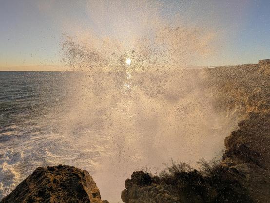 Waves breaking over the cliffs in Tarragona during sunset