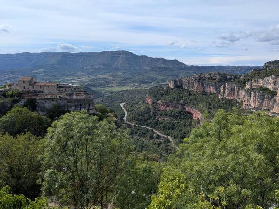 A distant road in the valley enclosed by dramatic rocky ridges 