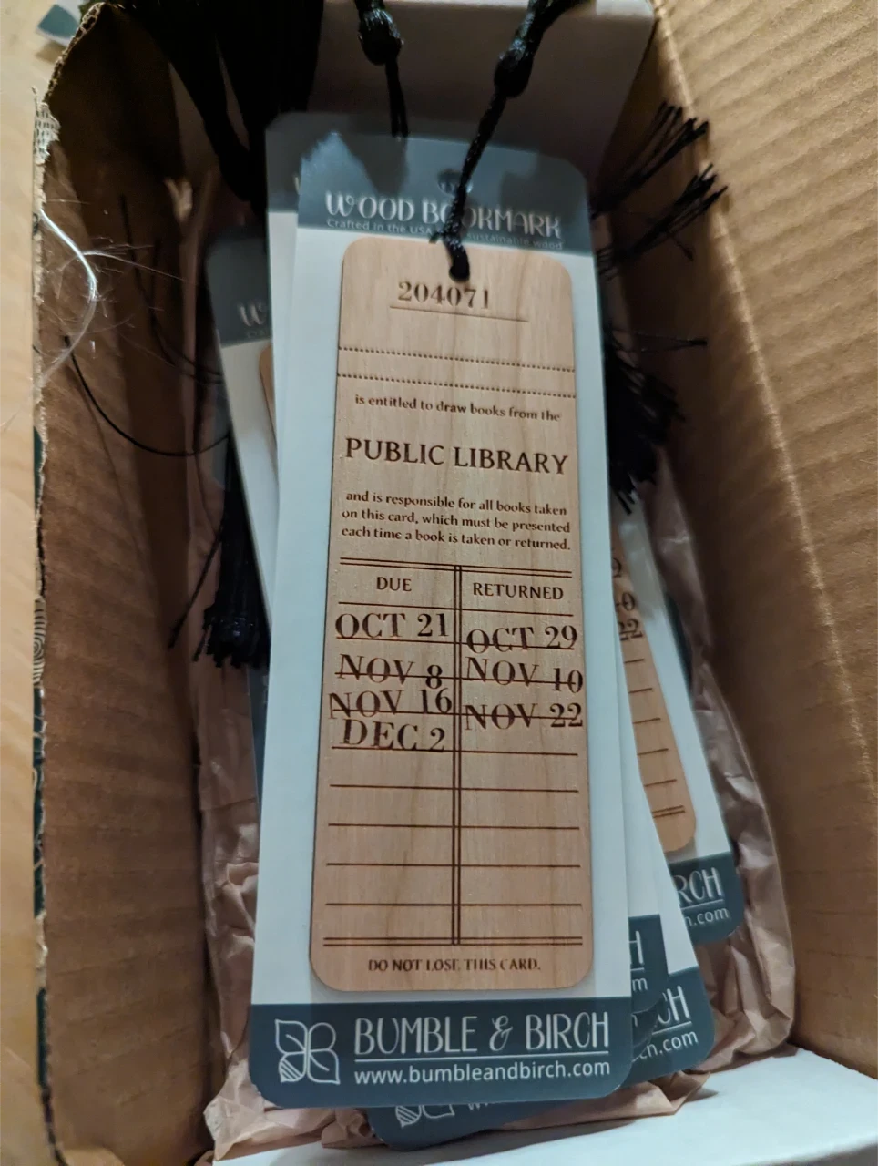 Wooden bookmark that is laser etched to look like a checkout card for a public library book