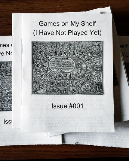 A stack of quarter-sized zines called "Games on My Shelf (I Have Not Played Yet)" Issue #001. There is an image of an old board game with a spiral layout in the centre of the page.