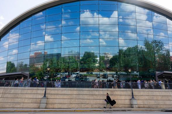 The sky is reflected in the windows of Stegeman Coliseum during the spring graduate Commencement ceremony at the University of Georgia.