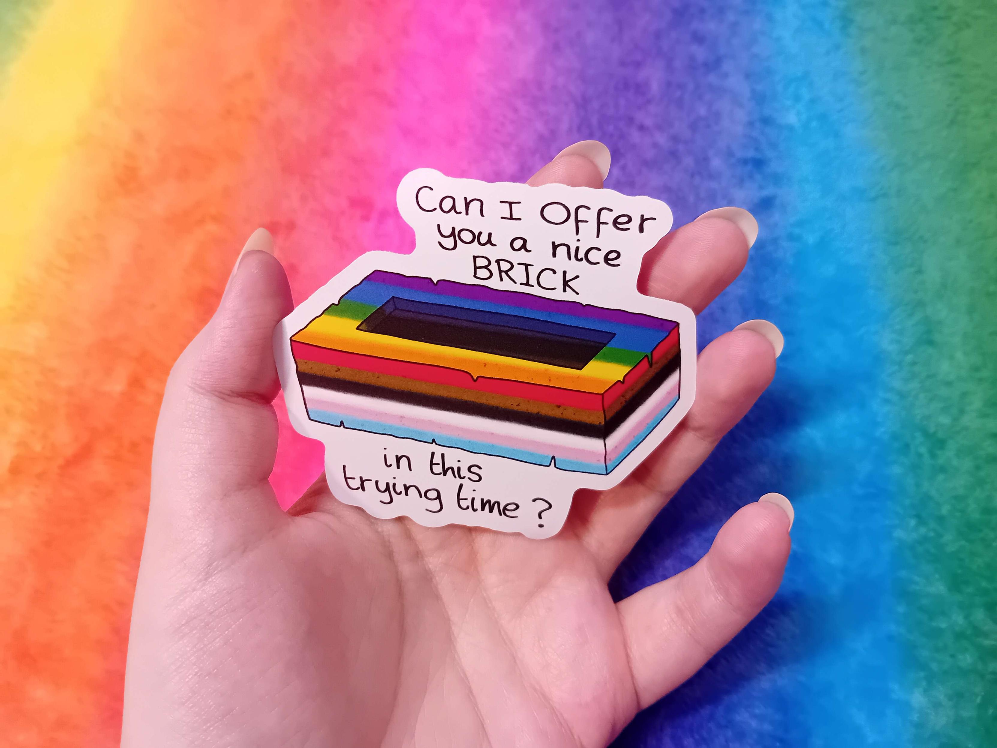 A photo of the sticker in my hand to show off the dimensions (77mm x 80mm)