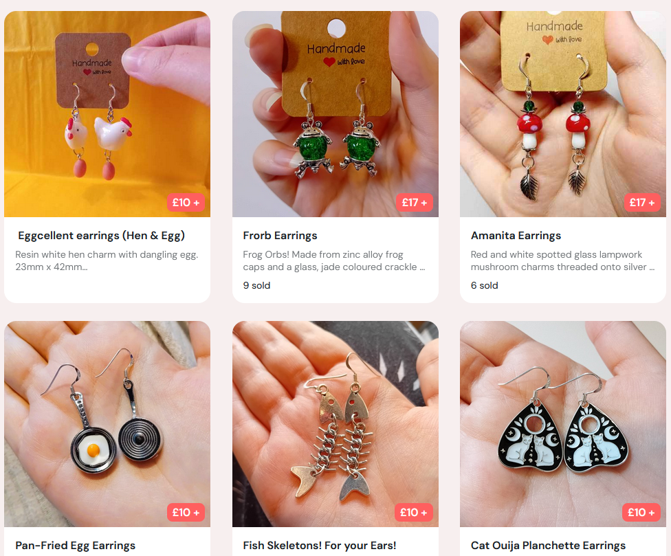 6 listings of fishhook earrings with themes ranging from amanita mushrooms, fried eggs in pans, segmented fish skeletons, cat themed mini Ouija planchettes, hens with dangly eggs, and frogs.