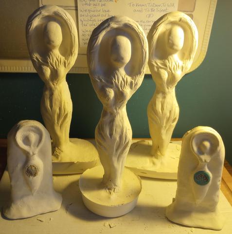 I have cast 5 new plaster figurines, three of the 9" tall Divine Feminine molds, two on a wide base and one on a shippable smaller, heavier base. These will be beta tests for their respective motifs, and will live in my glass door altar cabinet. 

Also there are two of the 4" stele molds with some beaded jewelry embedded. These will eventually be for sale, once I have figured out the best colors and embellishments to go with their jewelry.

The plaster needs to cure a few days, then I will repair / sand the plaster, and seal it with with a non-toxic decoupage glue. Then I'll paint them and add embellishments. 