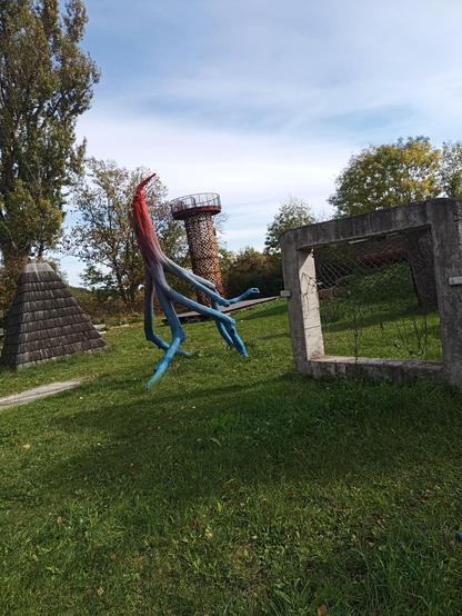 Wooden statue on a green field