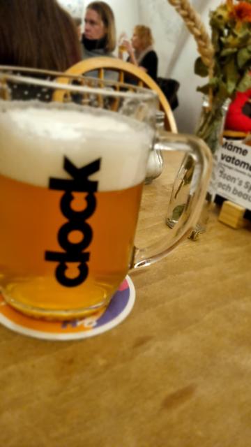A beer mug on a table. The beer is clock