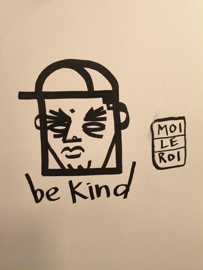 A graffiti that says be nice.