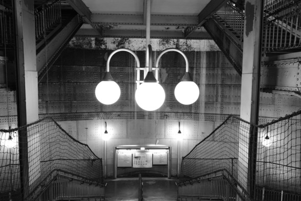 Black and white photo of the Cité metro station in Paris France. 