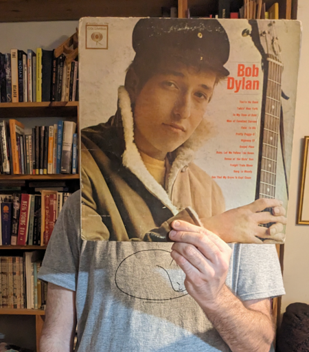 your DJ with Bob Dylan's 1st album in front of face