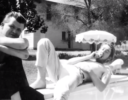 Bobby Petersen (arms on knees) + Laird Grant (reclining) relax poolside at Olompali