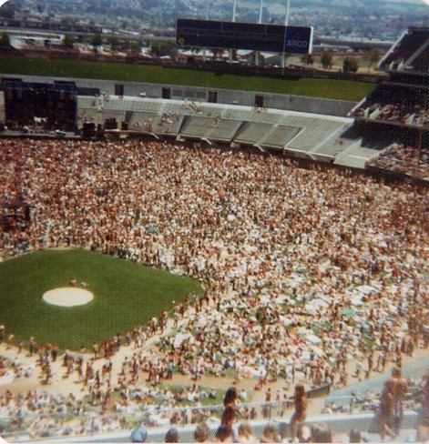 overhead photograph of Oakland Coliseum stadium with infield uncovered, stage in far center field