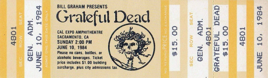 Grateful Dead mail order ticket on yellow ticket stock with the Skull & Roses logo