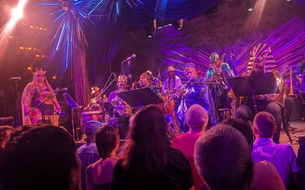 Left side of Arkestra on stage. Tara Middleton, Knoell Scott, horn players in Egyptian gear