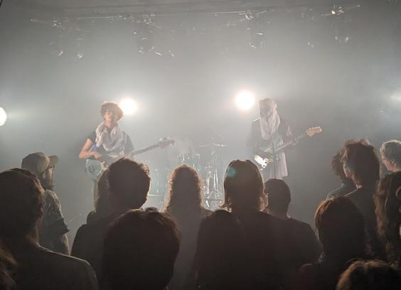 takaat onstage, backlit with smoke