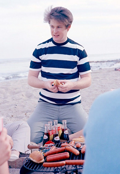 young Brian Wilson cracks a hot dog bun at a beach grill-out