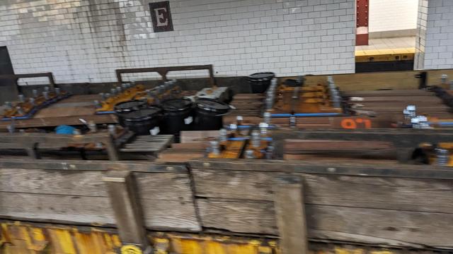 train car filled with pieces of subway track
