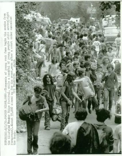 crowd flows into festival on roadway