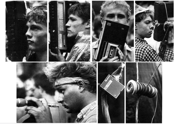 men hold up portable tape machines at music festival