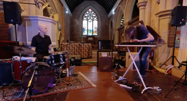 in a church, Chris Corsano plays drums, Mick Flower plays shahi baaja