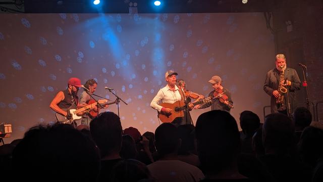 Will Oldham with band featuring electric guitar, bouzouki, viola, violin, and saxamaphone