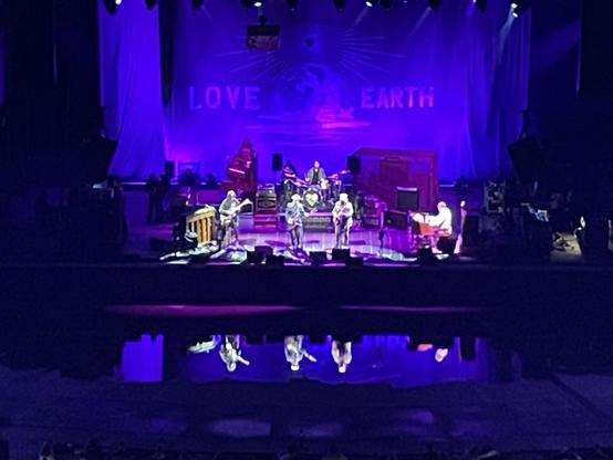 Neil Young & the Chrome Hearts onstage & reflected in water in front of stage
