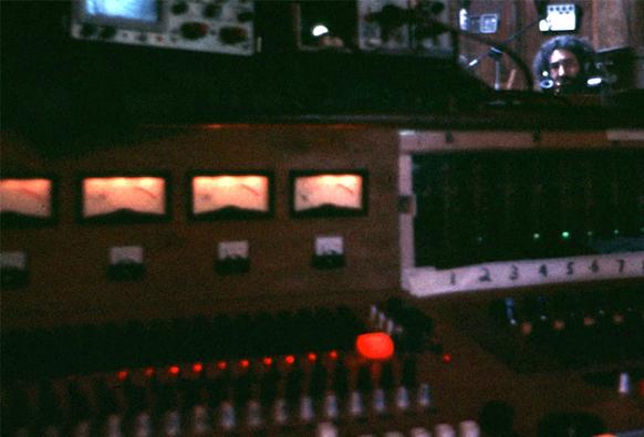 studio control room, Jerry Garcia peeks over edge of mixing console