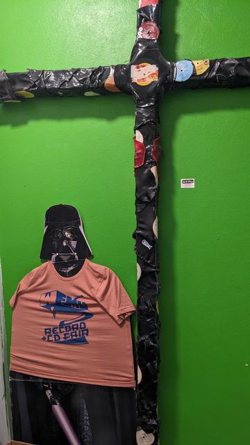 Darth Vader in Record Fair t shirt and vinyl crucifix