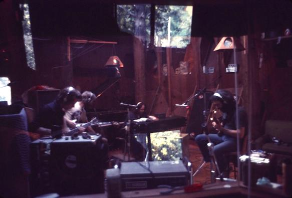 the gang with headphones on, recording at Ace's, through control room glass