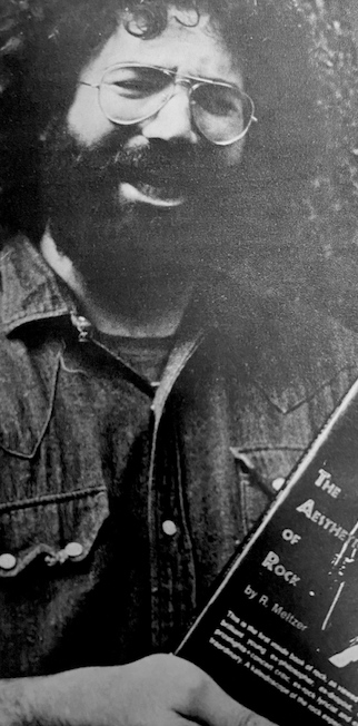 Jerry Garcia holds a copy of "the Aesthetics of Rock" by R. Meltzer, from Circus Magazine, 9/70