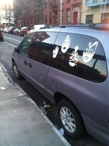 gray minivan with KISS faces