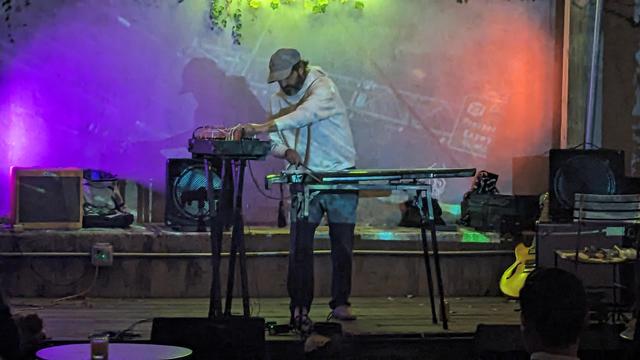 Brian Weitz adjusts synth while bowing guqin