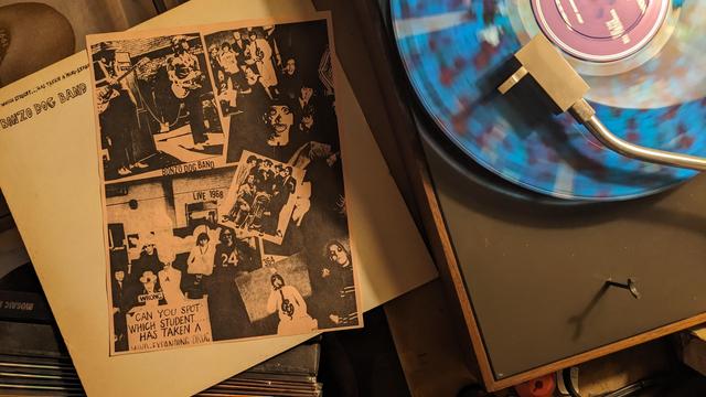 LP on blue marbled vinyl and single sheet of paper with photos