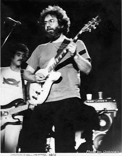 Jerry Garcia plays guitar, John Kahn behind him