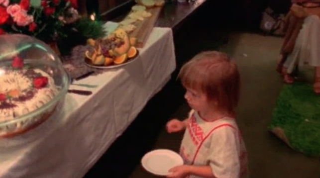 Sage Scully backage at Winterland with paper plate and single grape