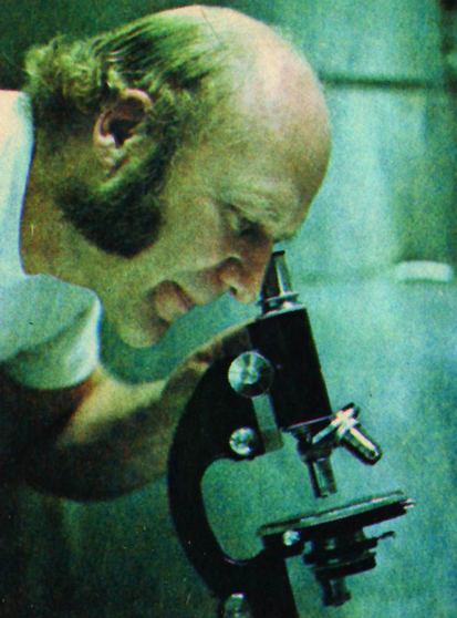 Chuck Kesey peers into microscope
