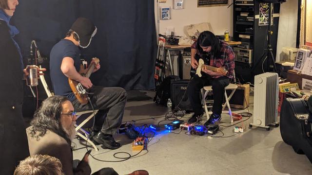 Tom Malach and Danny Arakaki play guitar 