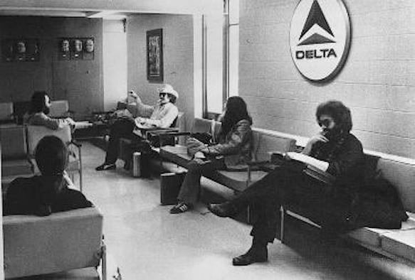 the Jerry Garcia Band waits for a flight in an airport lounge