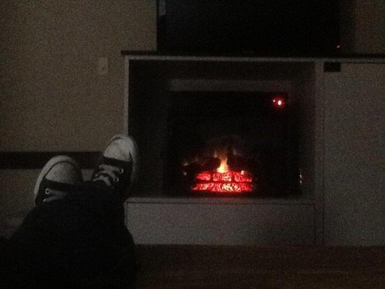 electric fireplace with reclining feet in foreground 