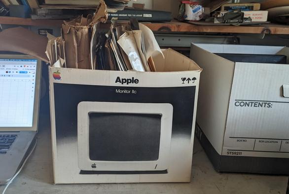 Apple IIc monitor box with files sticking out of it