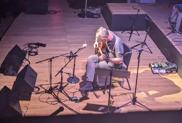 Shane Parish plays acoustic guitar
