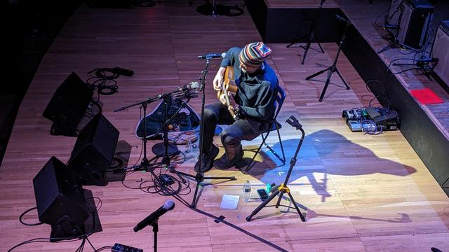 Kris Gruda plays acoustic guitar