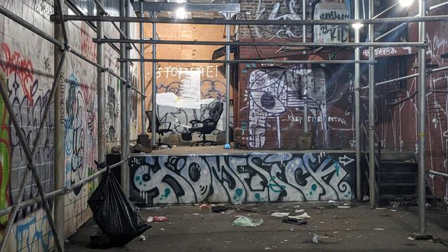 graffiti covered loading dock with 2 office chairs