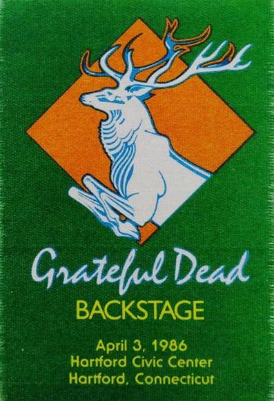 backstage pass with leaping deer inside orange square on green background