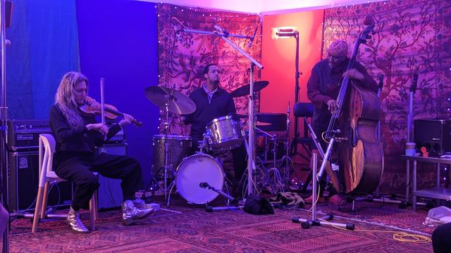 a trio of violinist, drummer, & bassist