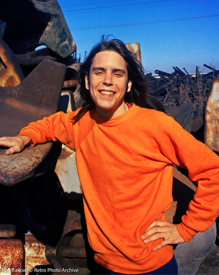 Bobby Weir, smiling in orange sweatshirt